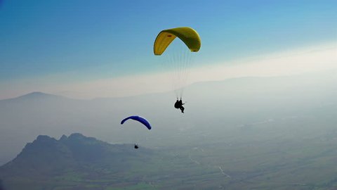 MACEDONIA, PRILEP, NOV 02, 2014, Ultra HD 4K Paragliders fly over amazing mountain range during paragliding extreme sport competition on 2 November, 2014 at Prilep, Macedonia