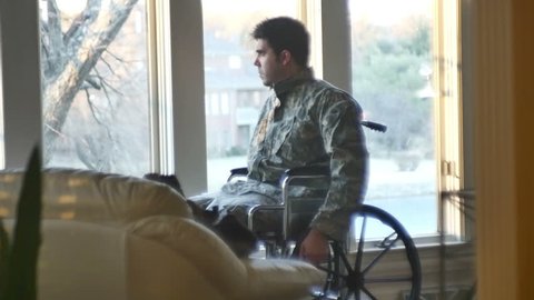 A sad veteran in camo and a wheelchair 