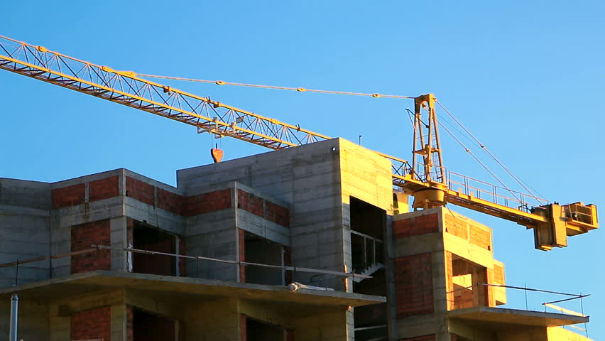 Crane working on the building at construction site