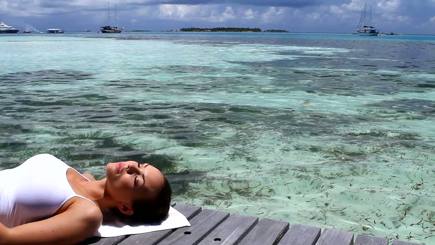 Beautiful woman resting near water at Maldives