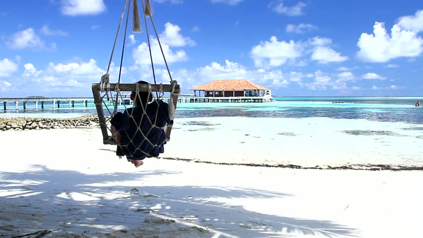 Beautiful and sexy woman resting at Maldives seaside