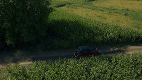 Vintage car aerial shot, driving on dirt road in wilderness side camera view