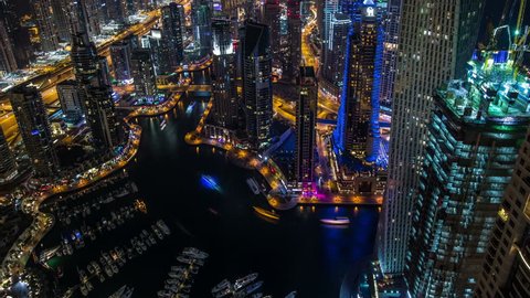 time lapse photography, aerial view Sheikh Zayed Road with Dubai Marina in United Arab Emirates at night, Photo Sequence shot in RAW, tilt