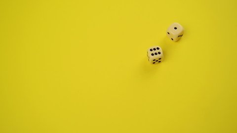 Rolling Dice on Yellow Background as Gambling and Probability concept, Throwing Six and One, 1920x1080 full hd footage.