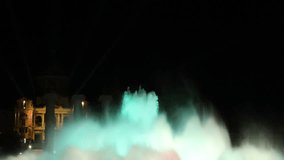 Magic fountain in Barcelona at night with blue color. Beautiful illuminated motion of water with special lighting. Tourist attraction.