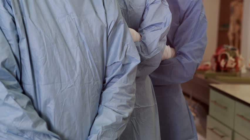 Portrait of Caucasian surgical team looking at the camera in operating theater in high quality 4k format , Healthcare workers in the Coronavirus Covid19 pandemic | Shutterstock HD Video #8562166