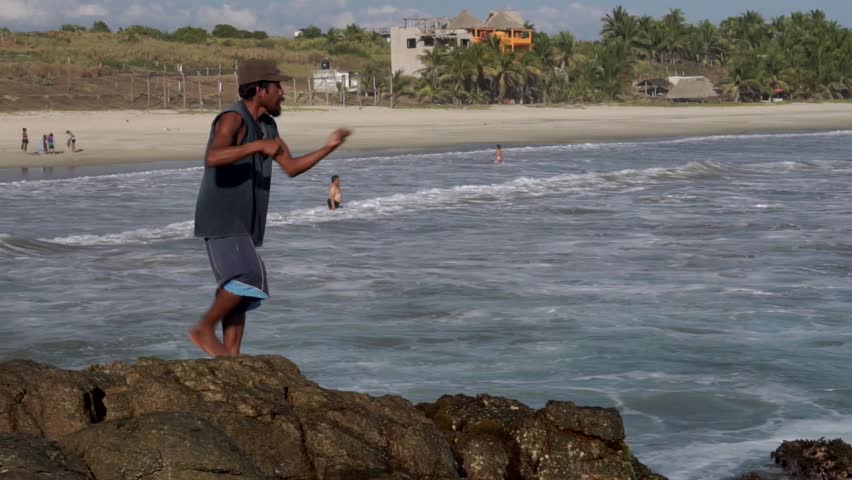 man fishing standing on the cliff
