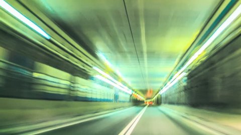 Blur of car racing through city tunnels, loop