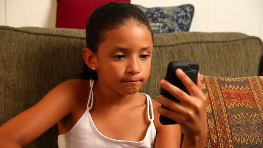 A young girl video chats on her mobile smartphone.