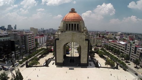 General aerial shot of the Monumento a la Revolucion, surrounded by lots of buildings in a panoramic view of Mexico City
