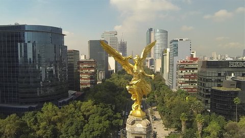 MEXICO CITY - CIRCA 2014
Aerial round shot of the Angel de la Independence column and view of the most of the city, buildings and streets around in Mexico City
