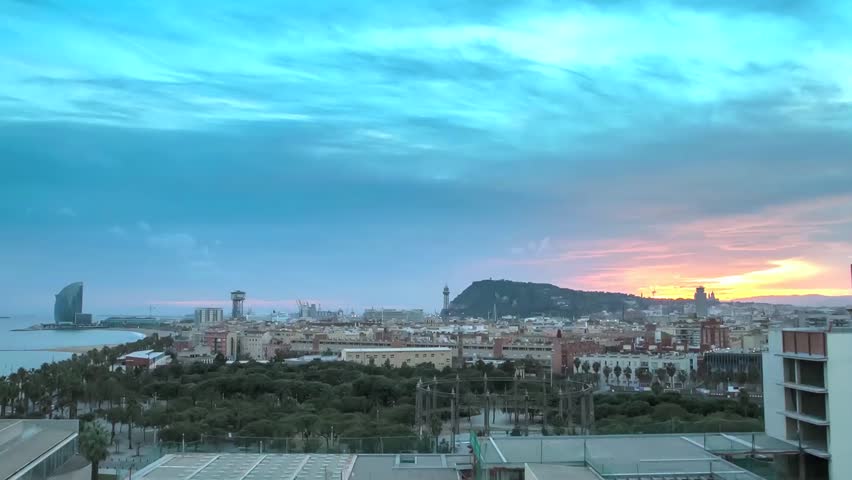 Barcelona skyline at dusk with Montjuic mountain behind