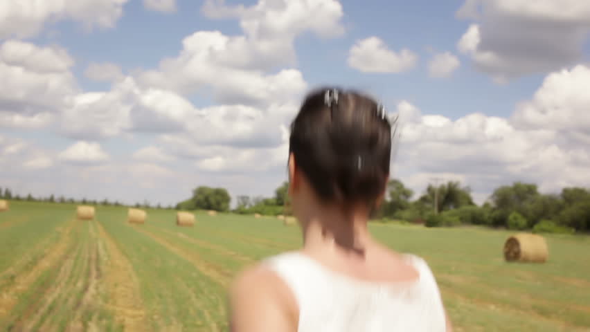 Young woman runs in field
