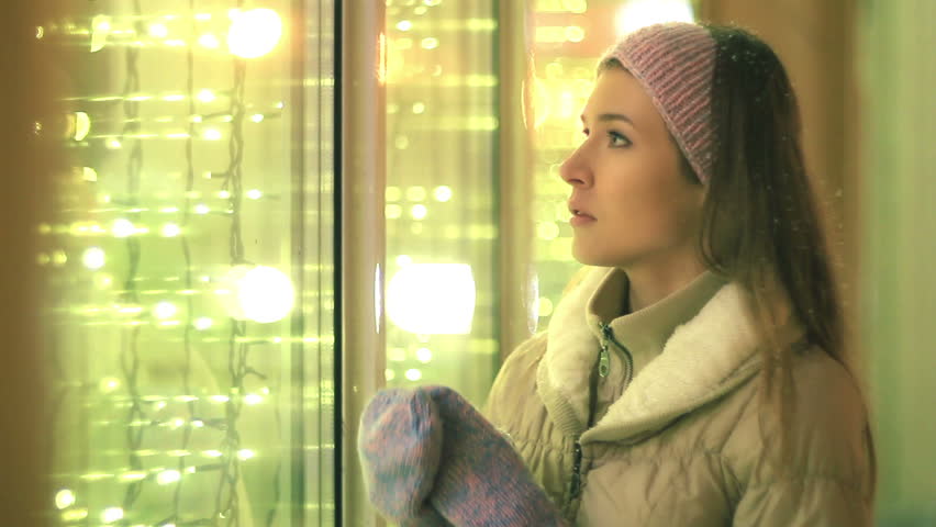 Young girl dreaming near the windows
