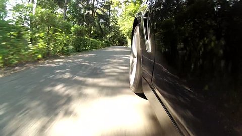 Low angle, car driving on a path