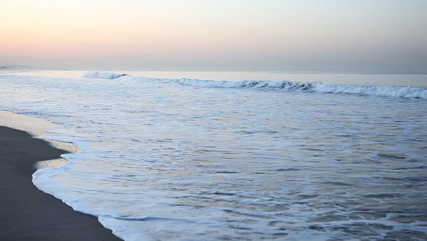 Gentle surf of Pacific Ocean at dawn, Santa Monica Beach, Los Angeles 