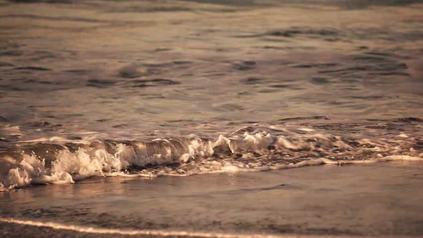 Gentle surf lapping against a beautiful pacific beach at dawn 