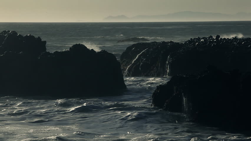 High waves smashing against dark cliffs at the pacific coast close to Los