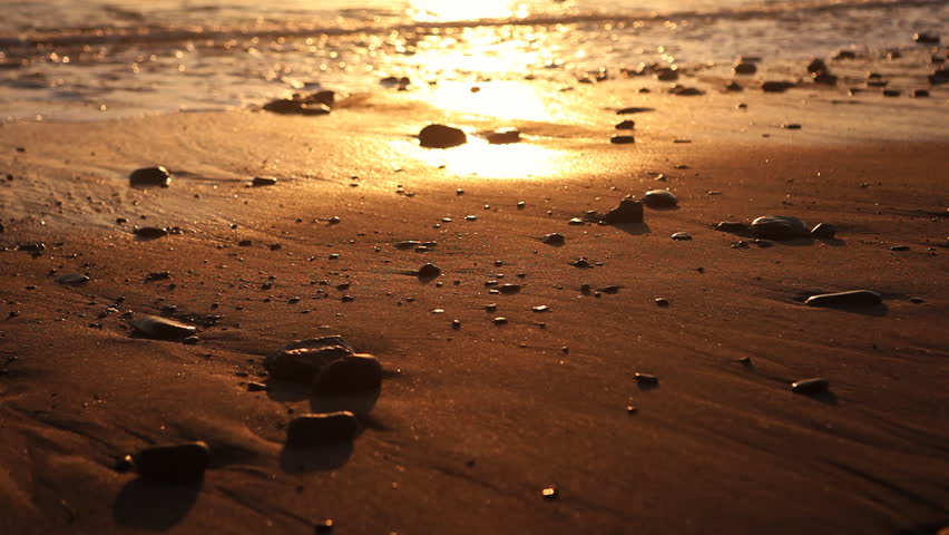 Gentle surf lapping against a beautiful pacific beach at dusk 