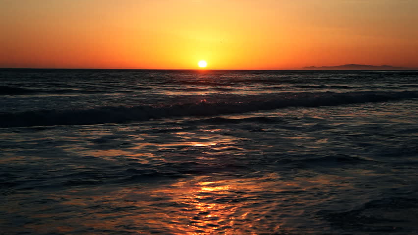 Beautiful sunset over pacific ocean with gentle surf 