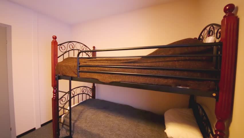 Interior of the small bedroom with two bunk beds and TV