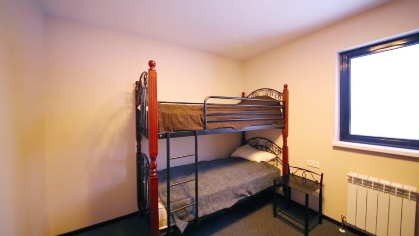 Interior of the small bedroom with two bunk beds and bedside table