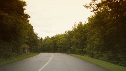 Long curve on a beautiful rural road. Color adjusted to give a romantic and dreamy look.