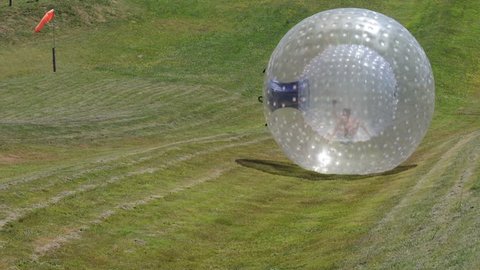 ROTORUA, NZL - JAN 18 2015:Visitor rides in ball rolling OGO Zorbing Rotorua.OGO Rotorua is now the only ball rolling operation in New Zealand to be Adventure Activity Safety Audit Certified.