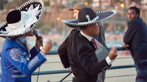 SANTA MONICA - JAN 14, 2015: festive Mexican Mariachi dancing on pier for tourists in Los Angeles California. Santa Monica is a beachfront city in LA, CA.