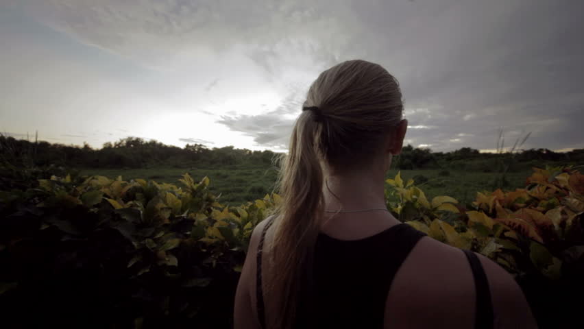 Young woman with touch pad outdoor. She taking pictures of beautiful green scenes
