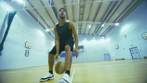 4K Mixed race basketball player dribbling the ball up the court, shot on RED EPIC