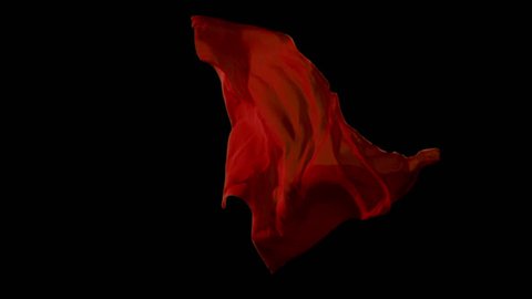 Red fabrics flowing in the air on black background. Slow motion