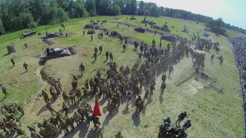 NELIDOVO - JUL 12, 2014: Troops of German and Soviet forces on field after fight during reconstruction Battlefield at summer day. Aerial view