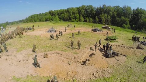 NELIDOVO - JUL 12, 2014: Spectators watch Soviet and German armies on field after fight during reconstruction Battlefield at summer day. Aerial view