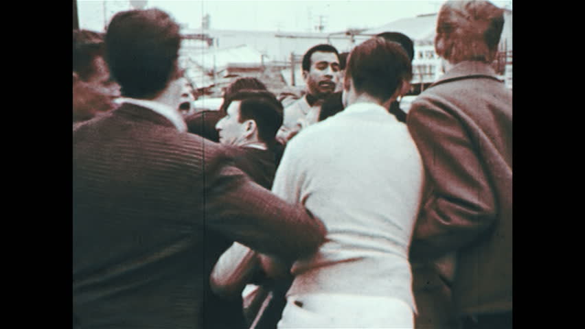 UNITED STATES 1960s : A group of people get into a fight after a car accident. | Shutterstock HD Video #8635696