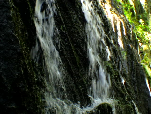 2 streams of water sliding down a rock face
