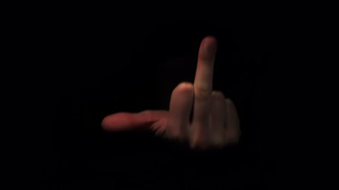 Female Hand Showing Middle Finger out of the Darkness. 4K Ultra HD 3840x2160 Video Clip