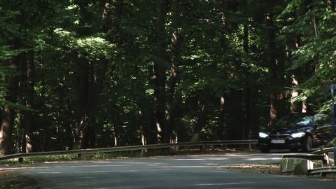 Romania, August 2014 - BMW 420d luxury car test on the road in forest scenery. The car perform brake test in front of the camera.