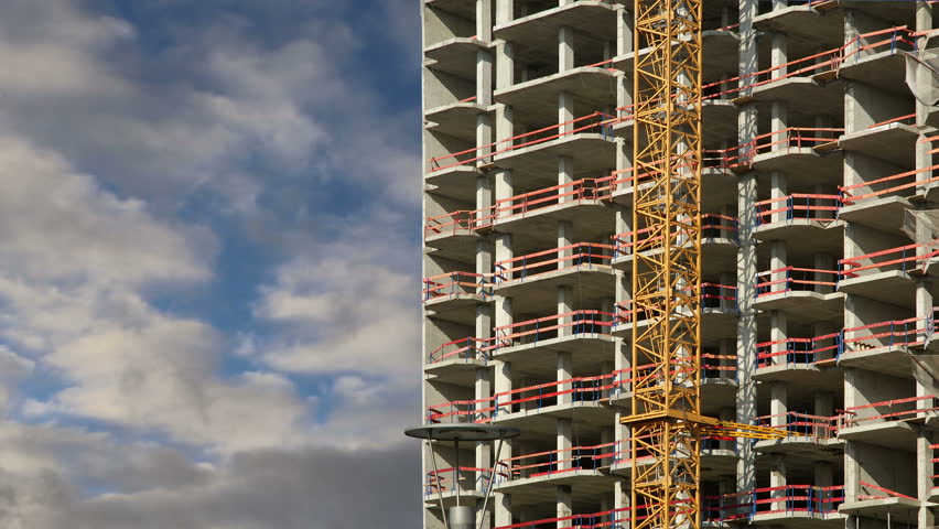 Construction tower crane at a construction site (time lapse) 