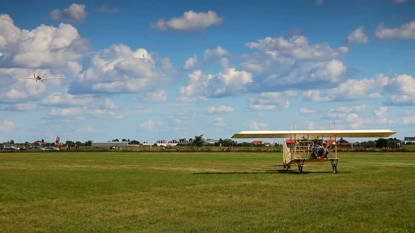 Airplanes landing, both modern and vintage models 