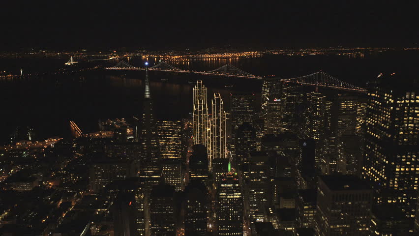 Aerial night illuminated Downtown city Skyscrapers financial district Oakland Bay Bridge San Francisco California USA 4K
