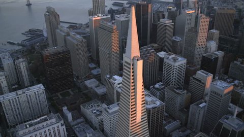 Aerial low level sunset view Transamerica Pyramid building Downtown city Skyscrapers San Francisco California USA 4K