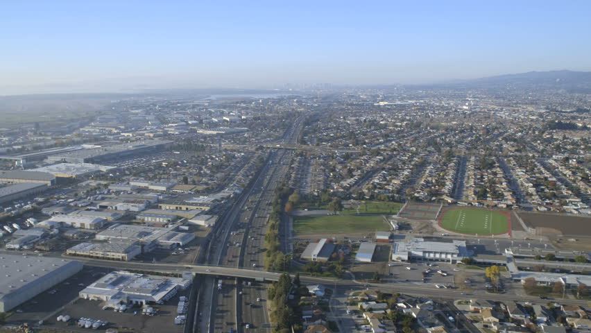 Aerial overhead vehicle Highway roads homes suburban business district transport San Francisco California USA 4K
