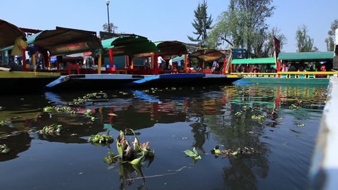 Xochimilco, Mexico City, traveling in a "trajinera" boat along the river.