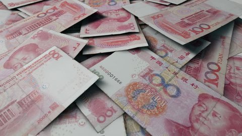 An extreme close up pan of a pile of randomly scattered chinese yuan banknotes