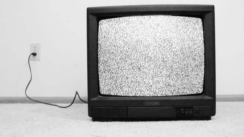 An old television from the 80's turned on with only static appearing o...