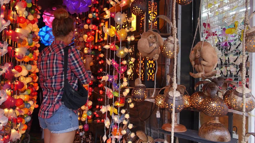 Woman in Gift Shop with Lantern or Lamp from Coconut. HD, 1920x1080