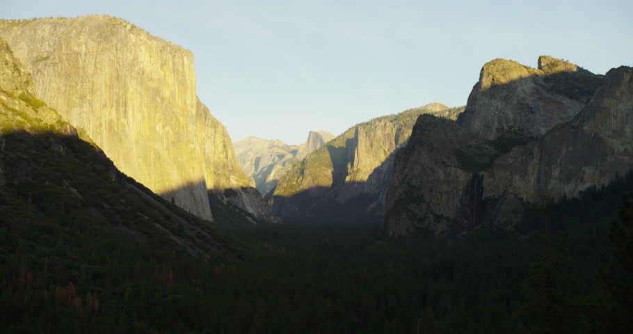Yosemite Valley can be seen from tunnel viewpoint during sunset. Yosemite National Park, California is visited by over 3.7 million tourists yearly. Shot on Red Epic.