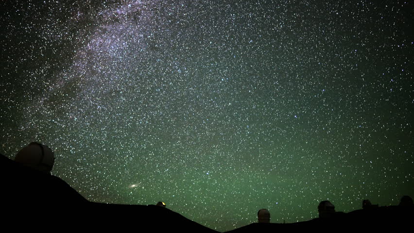 Astrophotography time lapse with zoom in motion of startrails over Mauna Kea Observatories in Hawaii