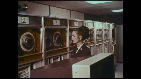 UNITED STATES 1970s :An officer observes computers as they record and store information.